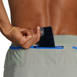 Brooks Sherpa 5-inch men's running shorts with zippered back pocket holding phone