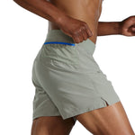 Man wearing Brooks Sherpa 5-inch running shorts in dark oyster green color