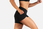 Woman wearing black Brooks Chaser 5-inch running shorts in active pose