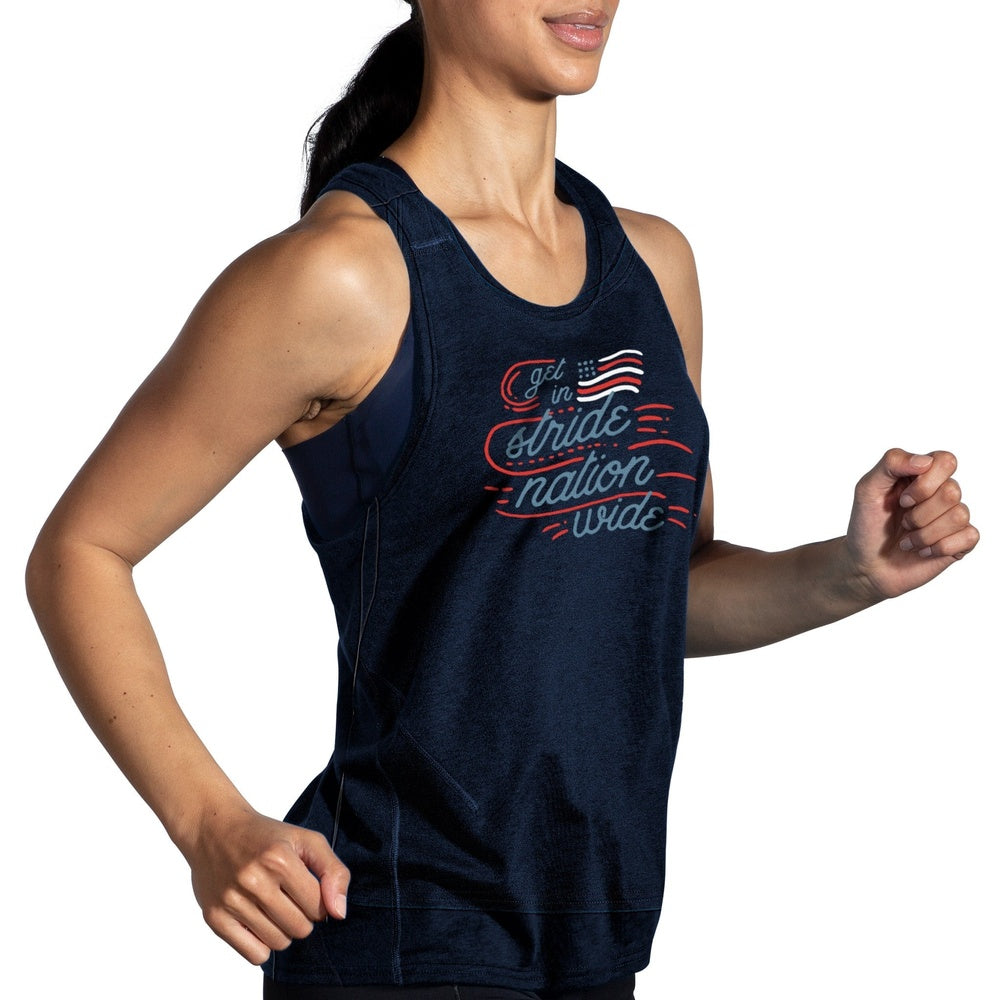 Woman running in Brooks Distance Tank 2.0 navy blue patriotic Run USA graphic tank top