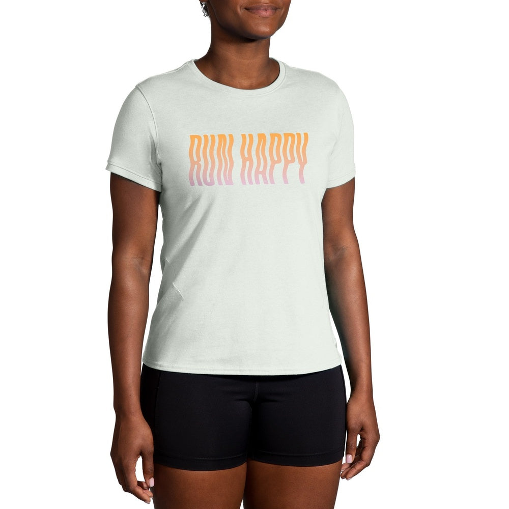 Woman wearing Brooks mint green running t-shirt with gradient Run Happy text