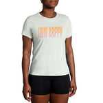 Woman wearing Brooks mint green running t-shirt with gradient Run Happy text
