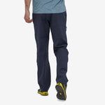 Man wearing Patagonia Men's Venga Rock Pants in navy blue, walking view