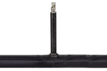 Black bicycle inner tube with valve stem on white background