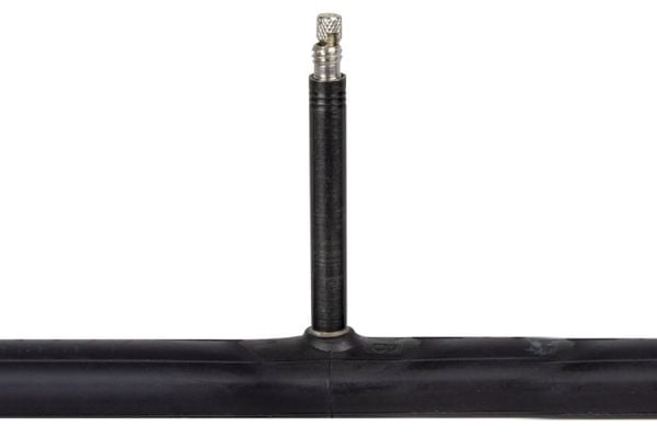 Black bicycle inner tube with valve stem on white background