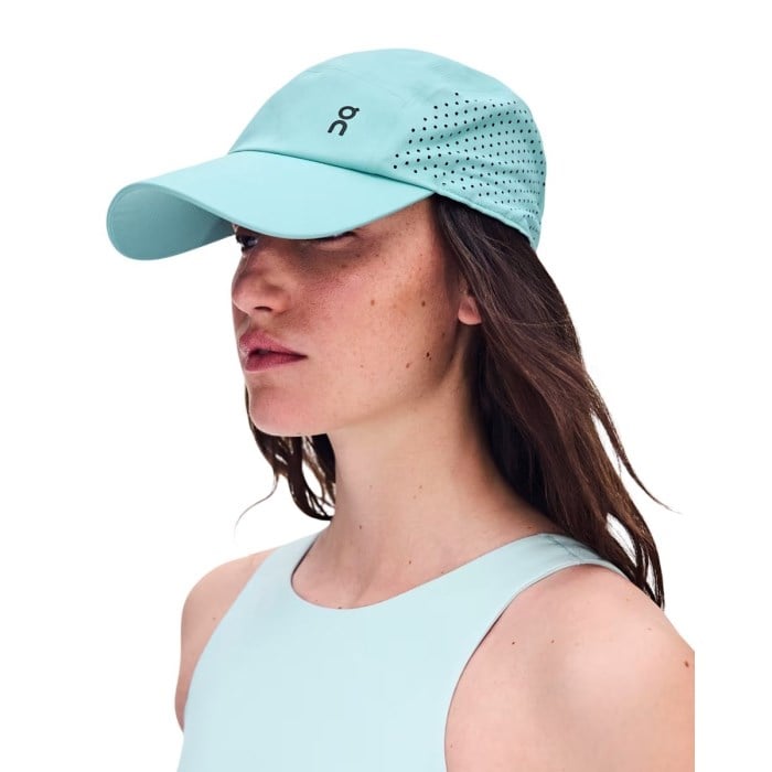 On Lightweight Unisex Cap in mint wash color worn by female model on white background