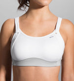 Woman wearing white Brooks Fiona sport bra with gray accents on clean background