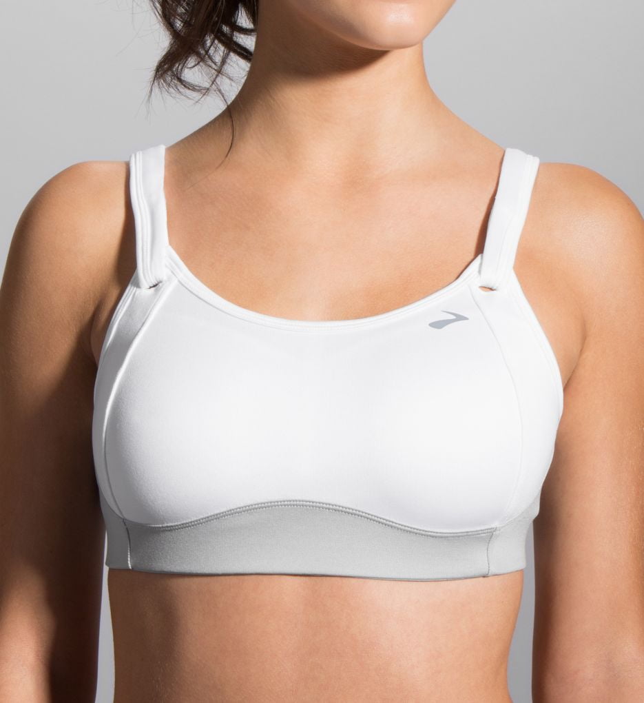 Woman wearing white Brooks Fiona sport bra with gray accents on clean background