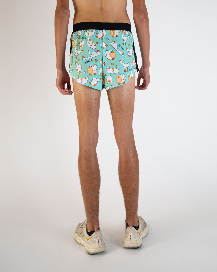 Back view of mint green running shorts with cartoon goose pattern on model