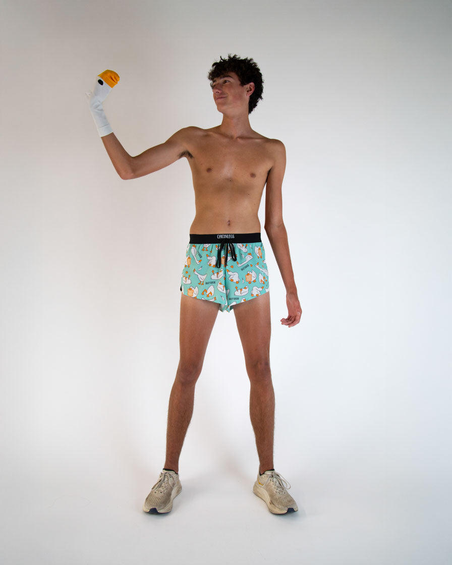 Man wearing ChicknLegs turquoise shorts with silly goose pattern and black waistband