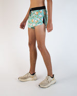 Man wearing ChicknLegs turquoise split shorts with silly goose pattern in studio photo