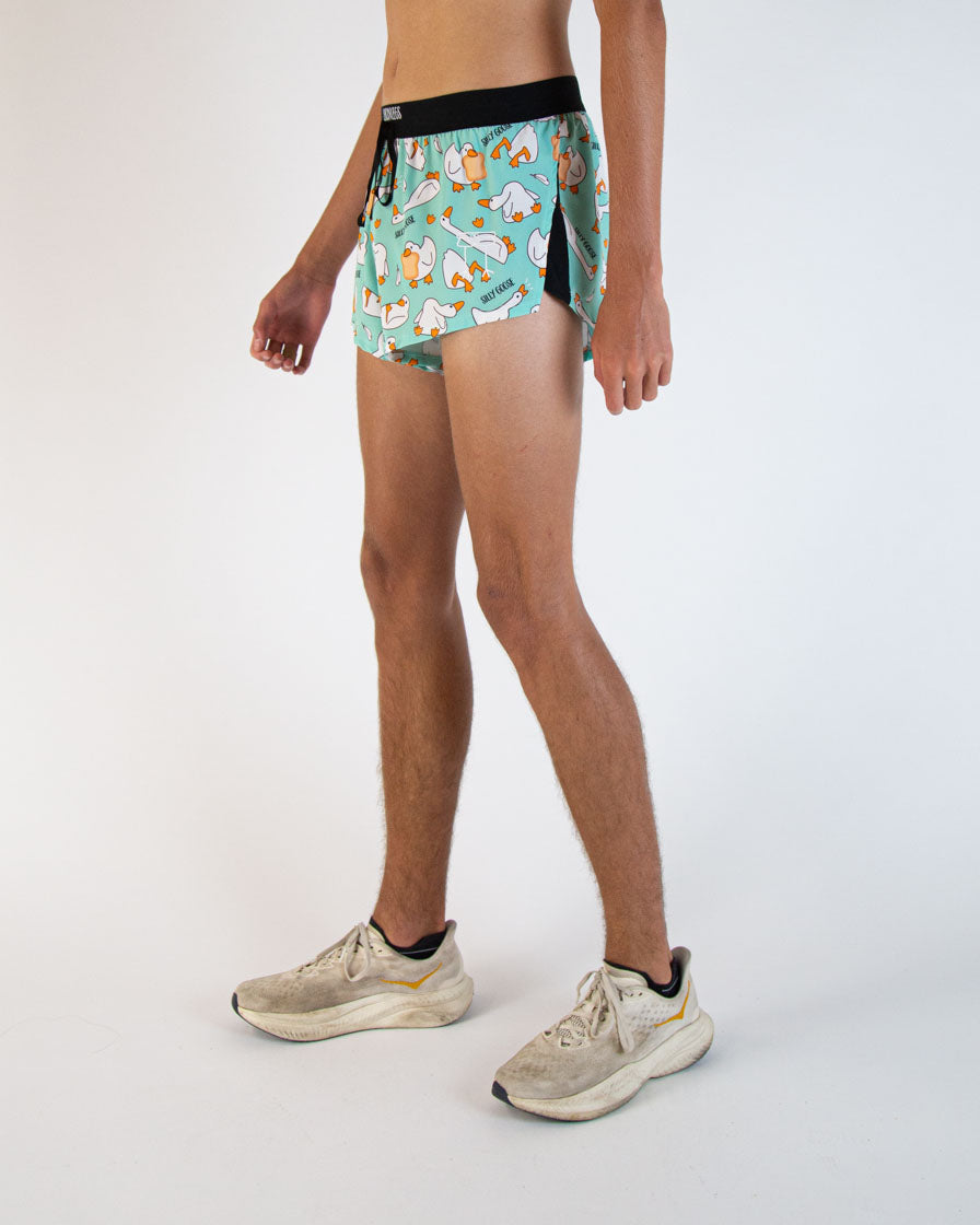 Man wearing ChicknLegs turquoise split shorts with silly goose pattern in studio photo