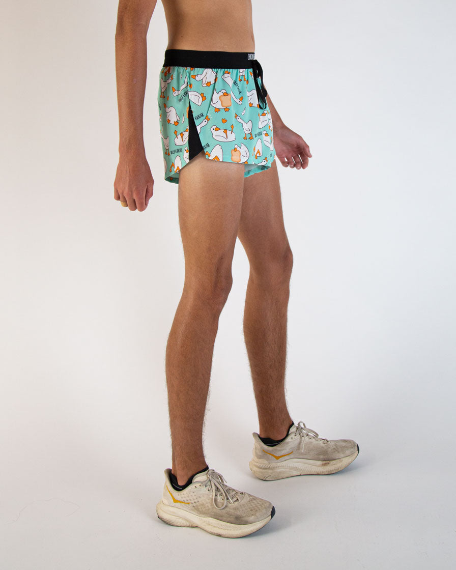 Man wearing ChicknLegs turquoise goose print 2-inch split running shorts