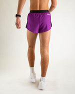 Back view of man wearing purple running shorts with black waistband and side panels