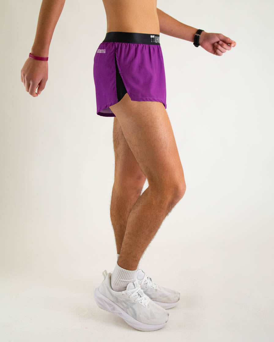 Man wearing purple athletic split shorts with black waistband and side panels