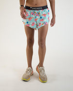 ChicknLegs men's split running shorts with flying pig pattern on light blue background
