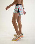 Man wearing ChicknLegs Flying Pigs 2-inch split running shorts with pink pig pattern