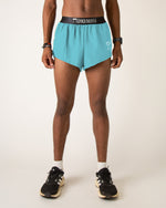 Man wearing Chicknlegs sky blue athletic shorts with black waistband and sneakers