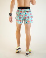 Man wearing ChicknLegs flying pig pattern running shorts in mint blue, back view