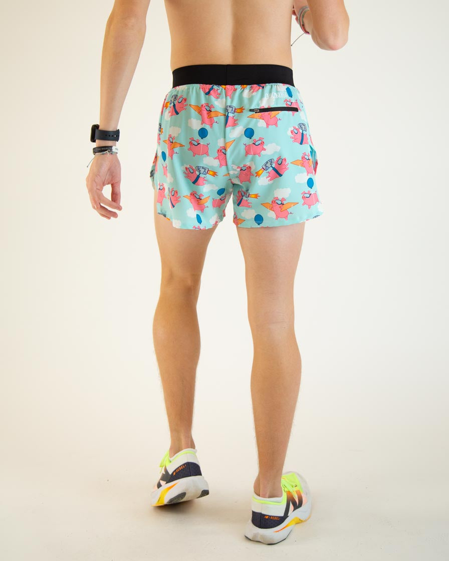 Man wearing ChicknLegs flying pig pattern running shorts in mint blue, back view