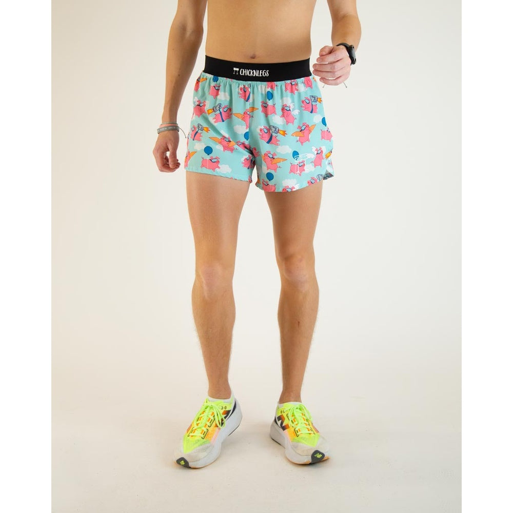 ChicknLegs men's running shorts with flying pigs pattern on light blue background