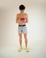 Man wearing ChicknLegs Flying Pigs 4-inch half split shorts in light blue
