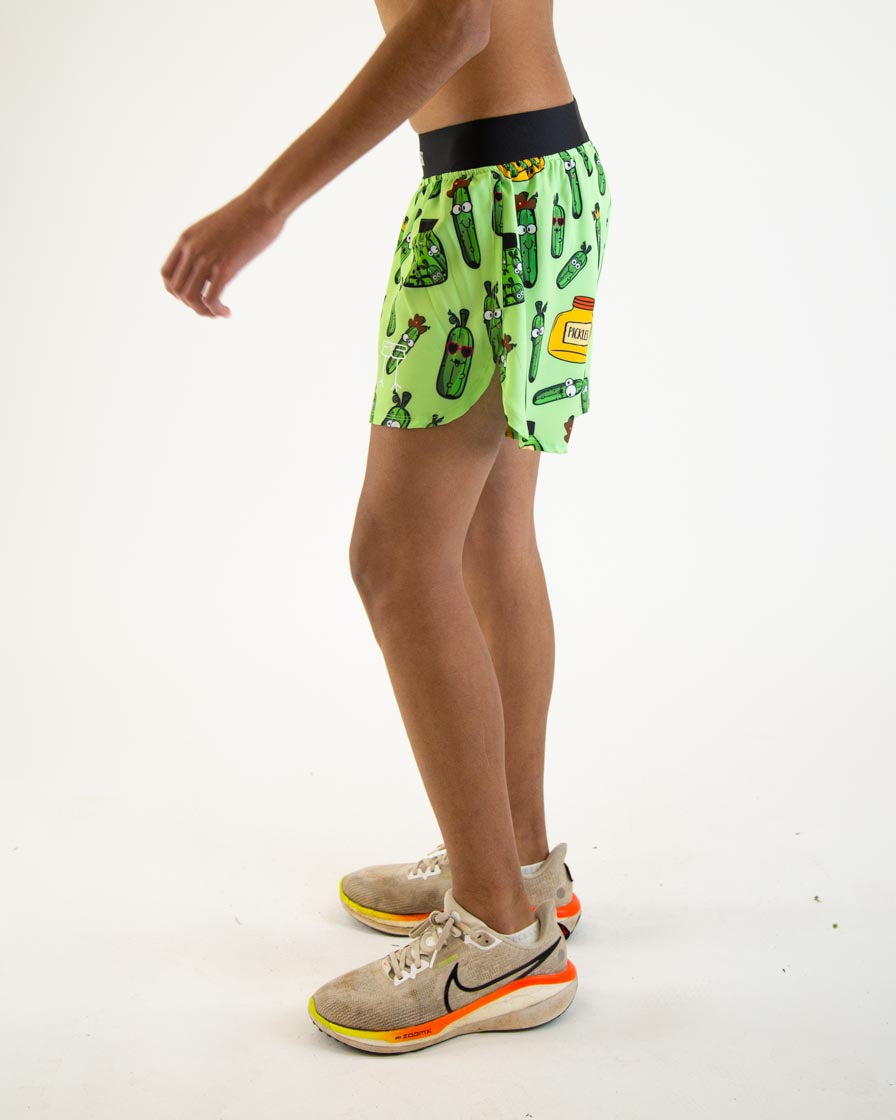 Man wearing bright green athletic shorts with pickle pattern and black waistband