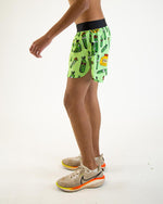 Man wearing bright green ChicknLegs running shorts with pickle print pattern