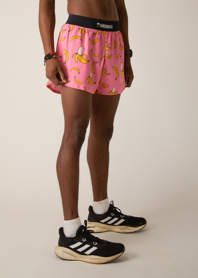 Model wearing pink running shorts with yellow banana print and black waistband