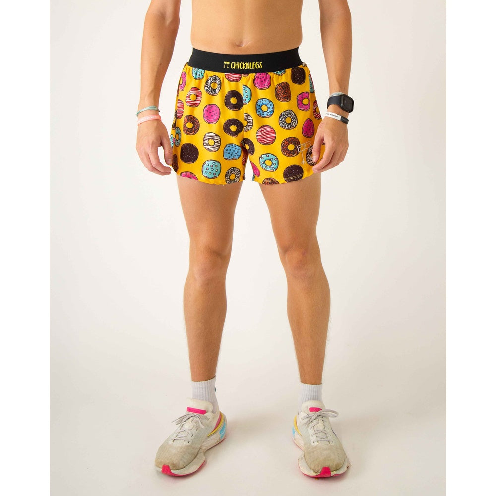 ChicknLegs men's yellow running shorts with colorful donut pattern on model