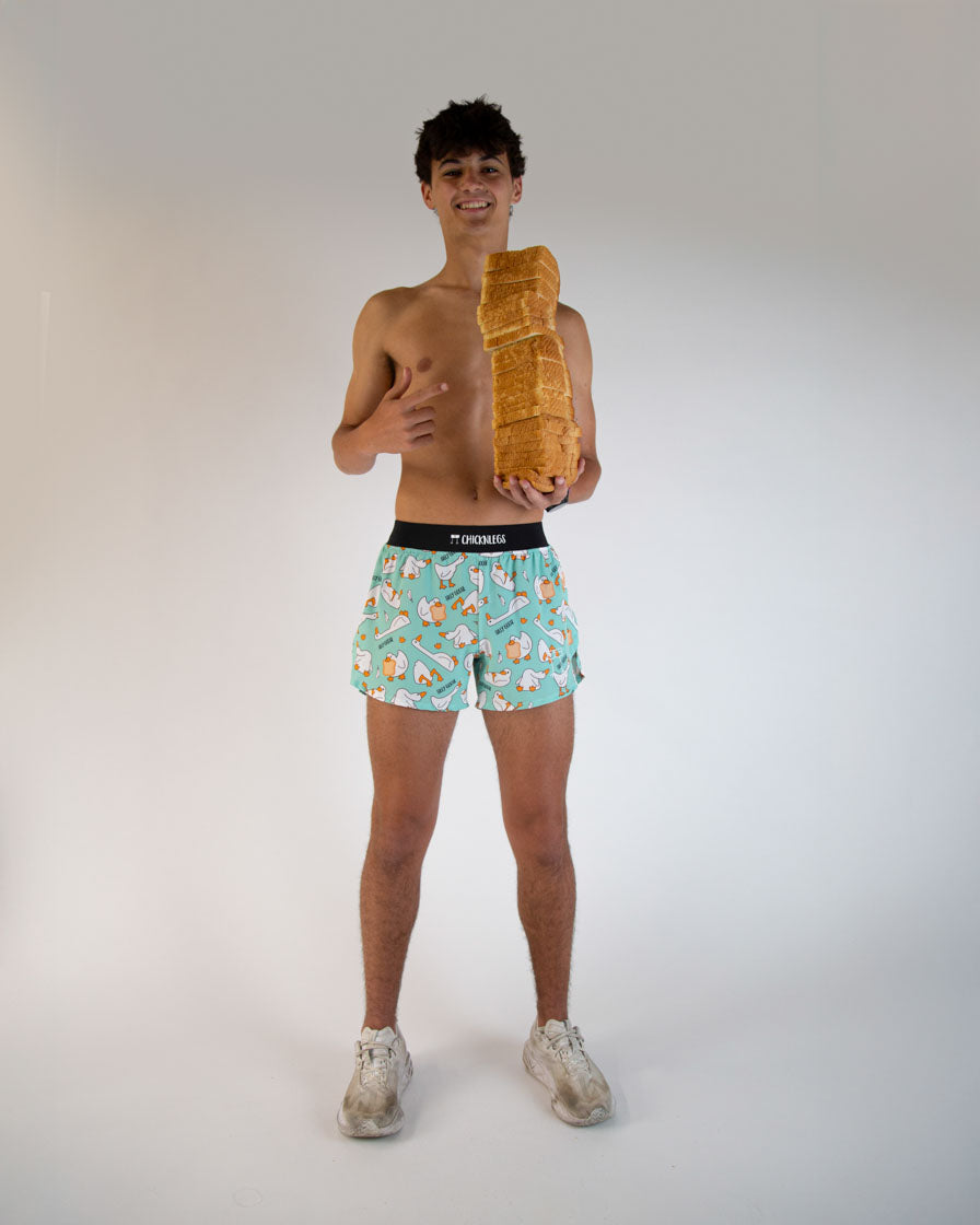 Man wearing ChicknLegs teal shorts with silly goose pattern in studio