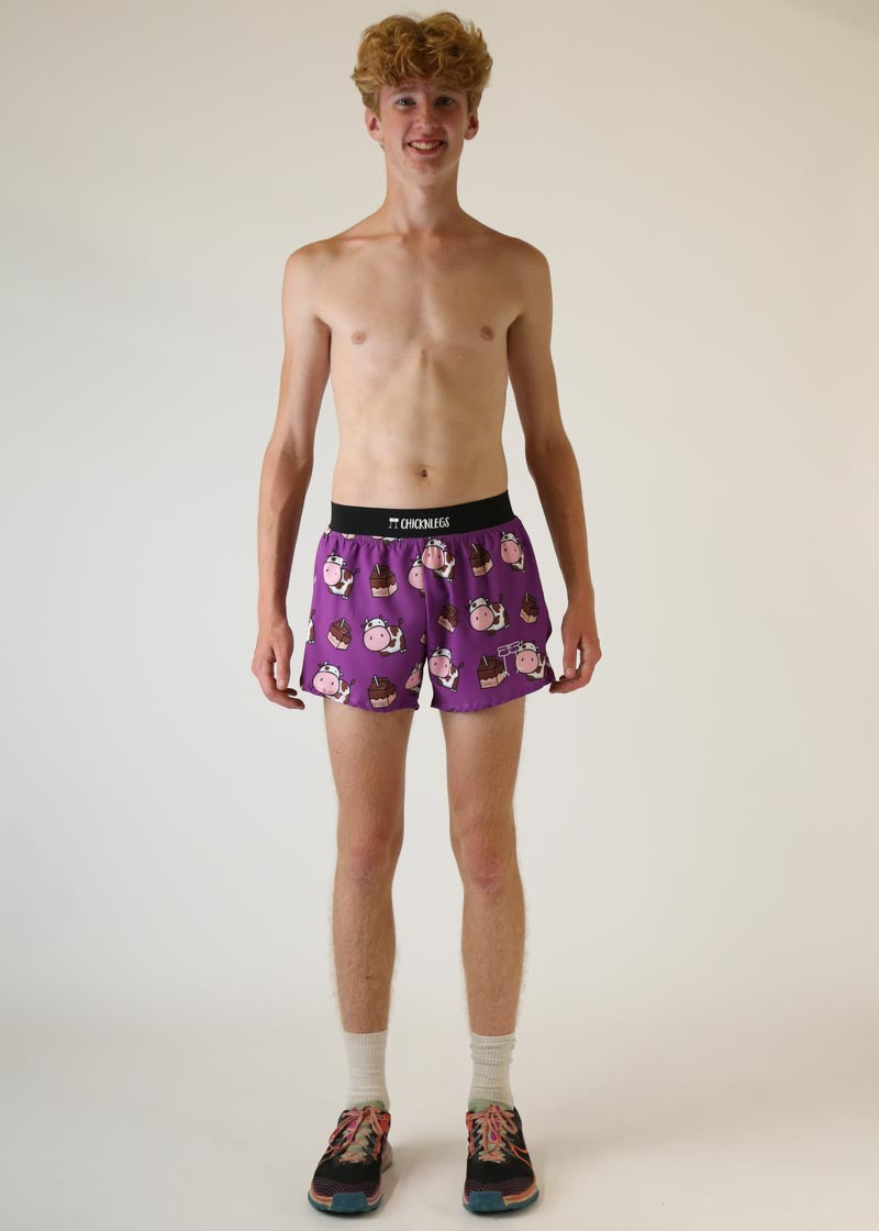 Man wearing purple ChicknLegs shorts with chocolate cow print pattern