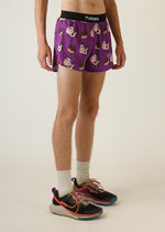 Purple ChicknLegs running shorts with cartoon cow pattern on model