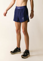 ChicknLegs navy blue 4-inch half split running shorts worn by male model with sneakers