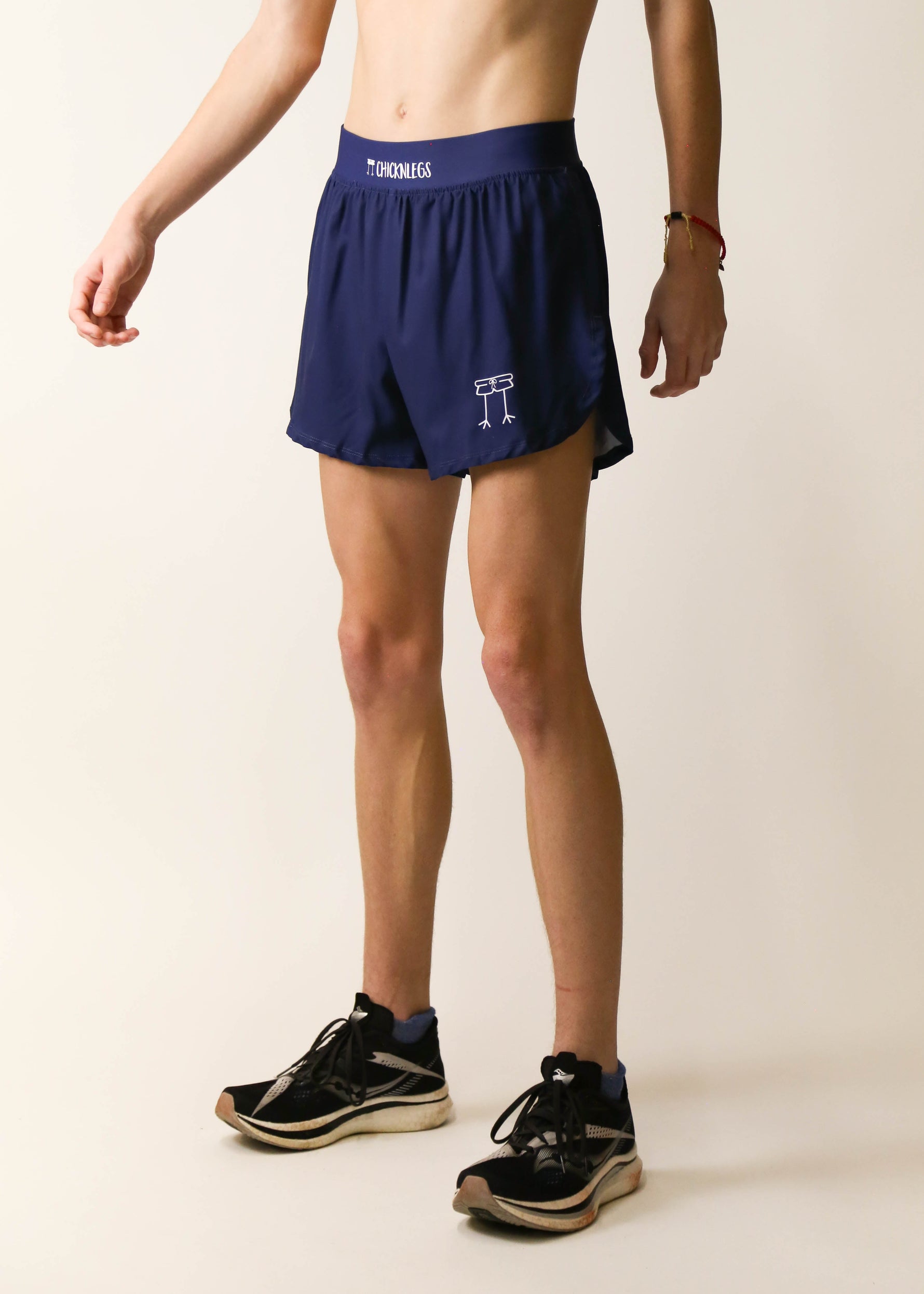 ChicknLegs navy blue 4-inch half split running shorts worn by male model with sneakers