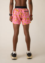 Back view of man wearing pink shorts with yellow banana print pattern