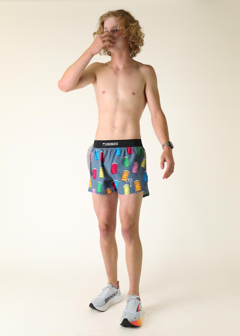 Man wearing gray ChicknLegs shorts with colorful porta potty print pattern