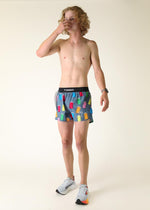 Man wearing ChicknLegs gray running shorts with colorful porta potty print pattern
