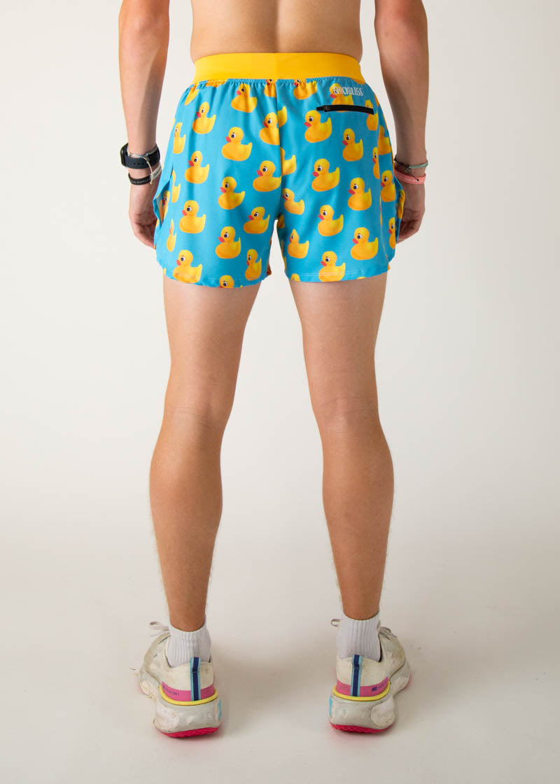 Back view of man wearing blue shorts with yellow rubber duck pattern