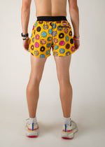 Yellow running shorts with colorful donut print pattern, back view on model