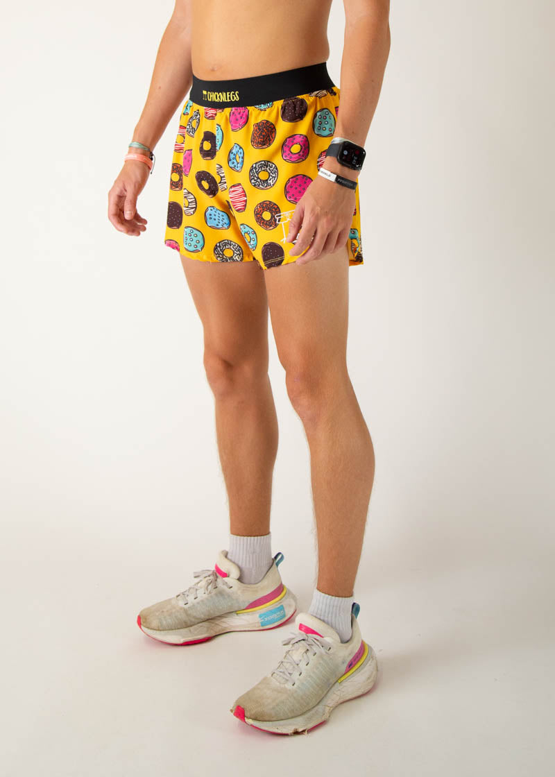 ChicknLegs men's yellow running shorts with colorful donut pattern