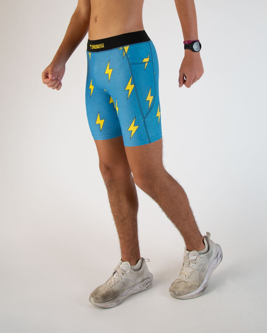 Man wearing blue athletic shorts with yellow lightning bolt pattern