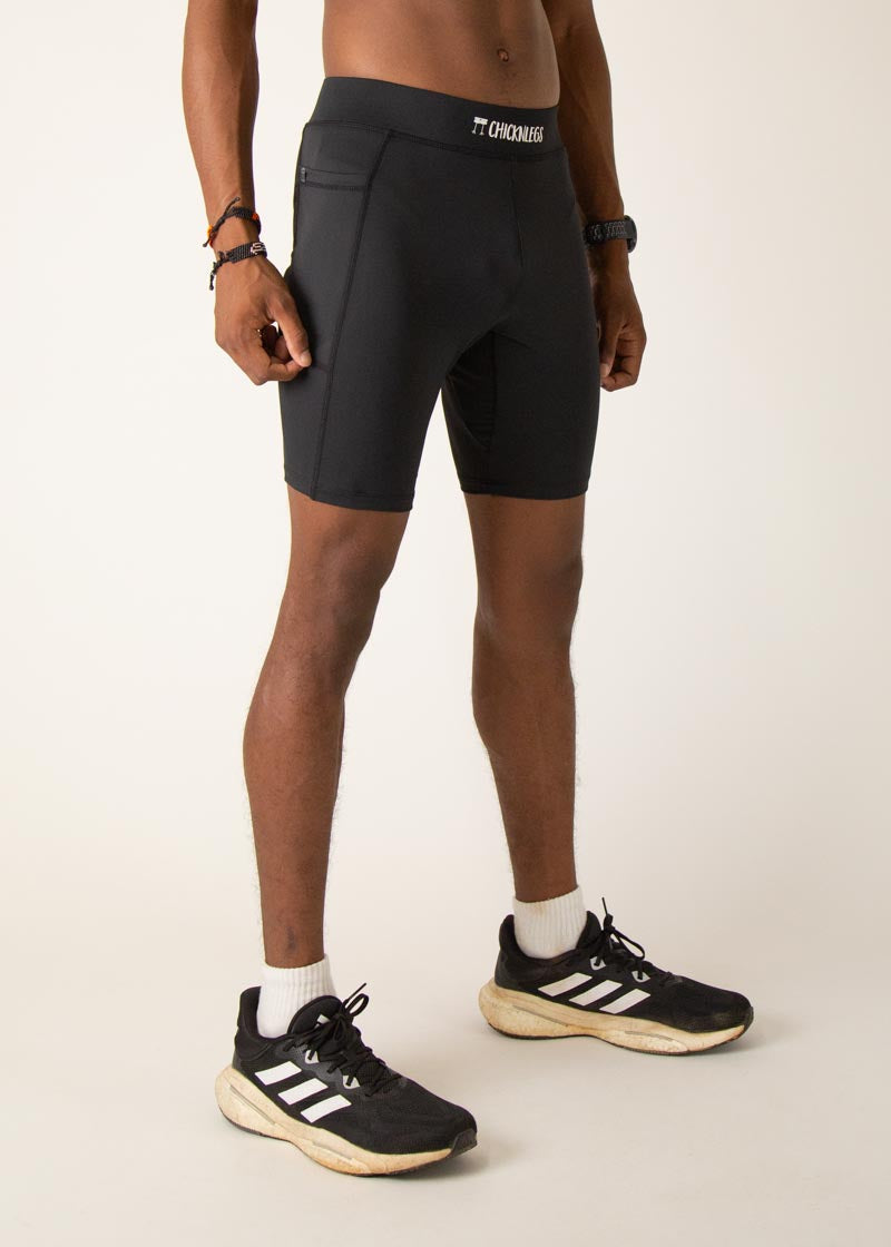 Man wearing black Chicknlegs 8-inch half tights with Adidas sneakers