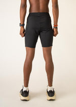 Man wearing black ChicknLegs 8-inch half tights, back view studio shot