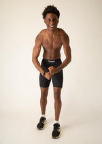 Athletic man wearing black ChicknLegs 8-inch half tights compression shorts