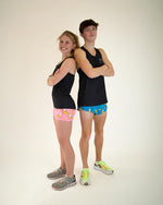 Two athletes wearing black ChicknLegs performance singlets with colorful shorts