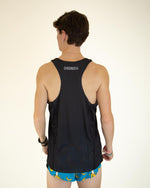 Back view of man wearing black ChicknLegs performance singlet with blue banana print shorts