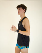 Man wearing black ChicknLegs performance singlet tank top in studio setting
