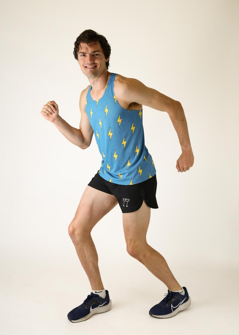 Man wearing blue performance singlet with yellow lightning bolt pattern while running