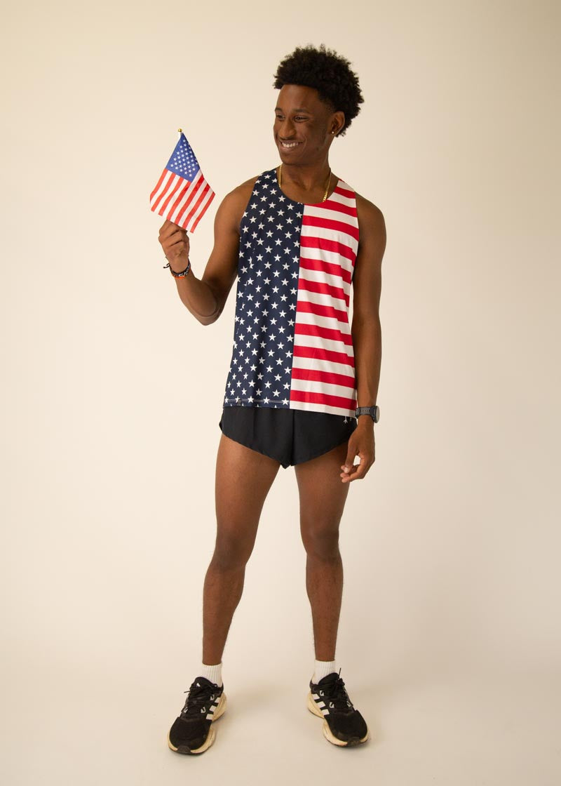 Man wearing ChicknLegs USA flag performance running singlet holding small American flag